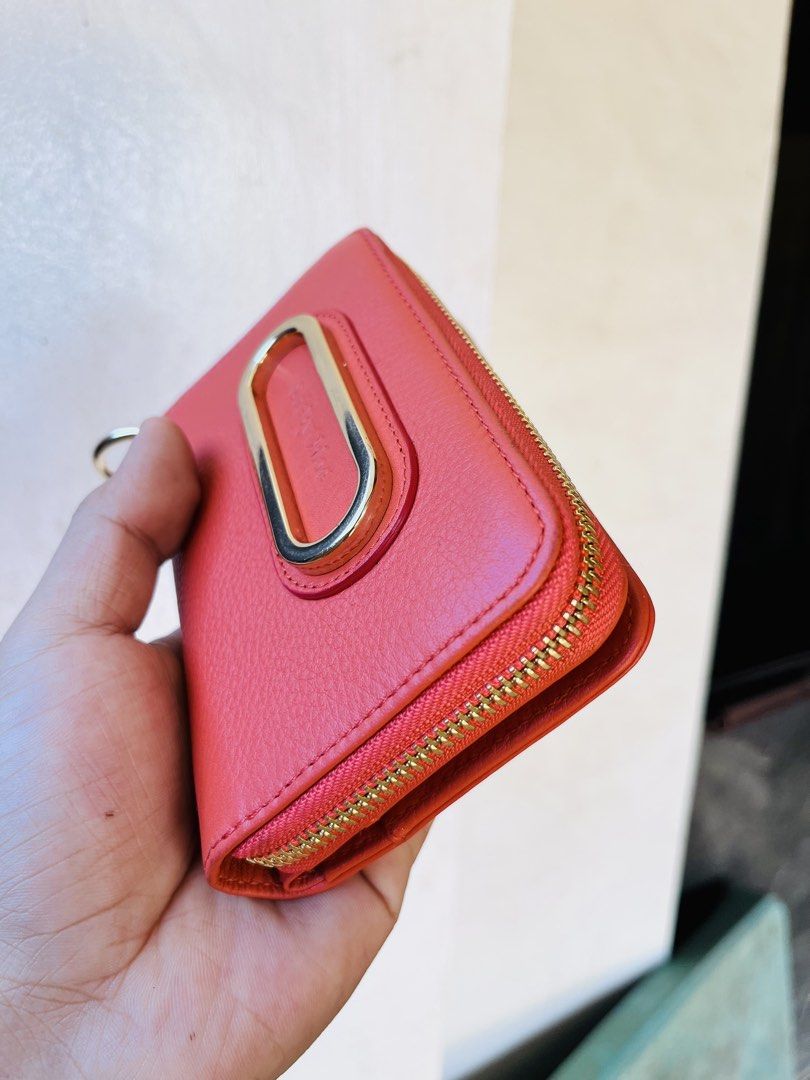 See By Chloé medium wallet (Category: Luxury Bags & Wallets) located in Ballesteros. Submitted by sat_b3 (Listing ID 1440005661, Image 2). Description: - See By Chloé wallet -orange color -rank A- malinis loob at labas - minimal signs of usage.. walang sira, bakbak, scratches or fadings… - Vibrant pebbled leather - Signature gold-tone metal accent - Zip-around closure - Interior card slots for organization - Stylish and practical for everyday use