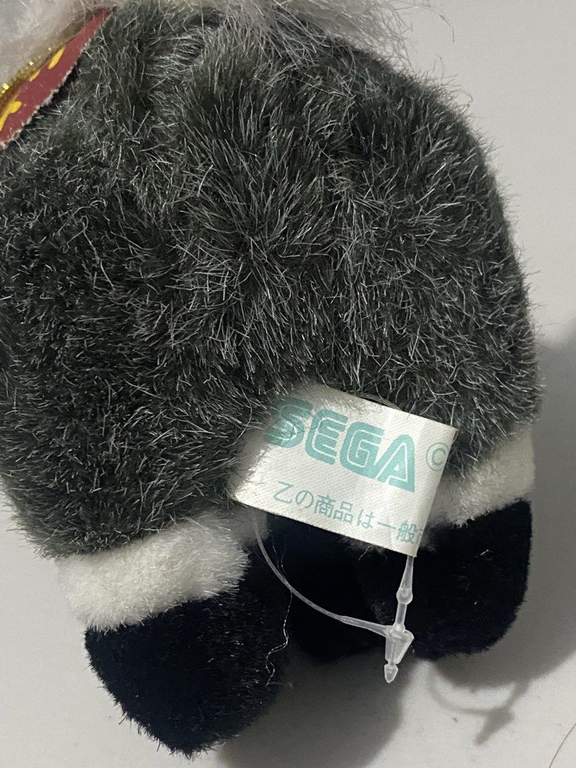 SEGA Plush Horse Toy (Category: Plushies & Soft Toys) located in Manila. Submitted by kuya_moto (Listing ID 1440180531, Image 3). Description: - Cute and fluffy plush horse toy from SEGA. - Features a dark grey body. - White mane and tail. - Black hooves. - Comes with a red collar. - Includes a gold string for hanging. - Perfect for collectors or as a charming decoration..