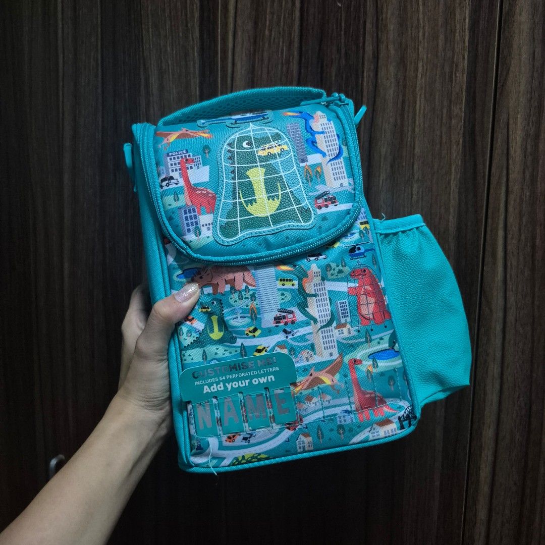 Smiggle Teal Blue Dinosaur Printed Lunch Bag (Category: Other Babies Going Out Needs) located in Manila. Submitted by mho.marie (Listing ID 1440100946, Image 1). Description: Original smiggle (bought in actual smiggle store overseas) Brandnew, never been used insulated lunch bag with sling Can put a lot of items inside if bought with lunch box & sip bottle (please other listings) cab give discount .