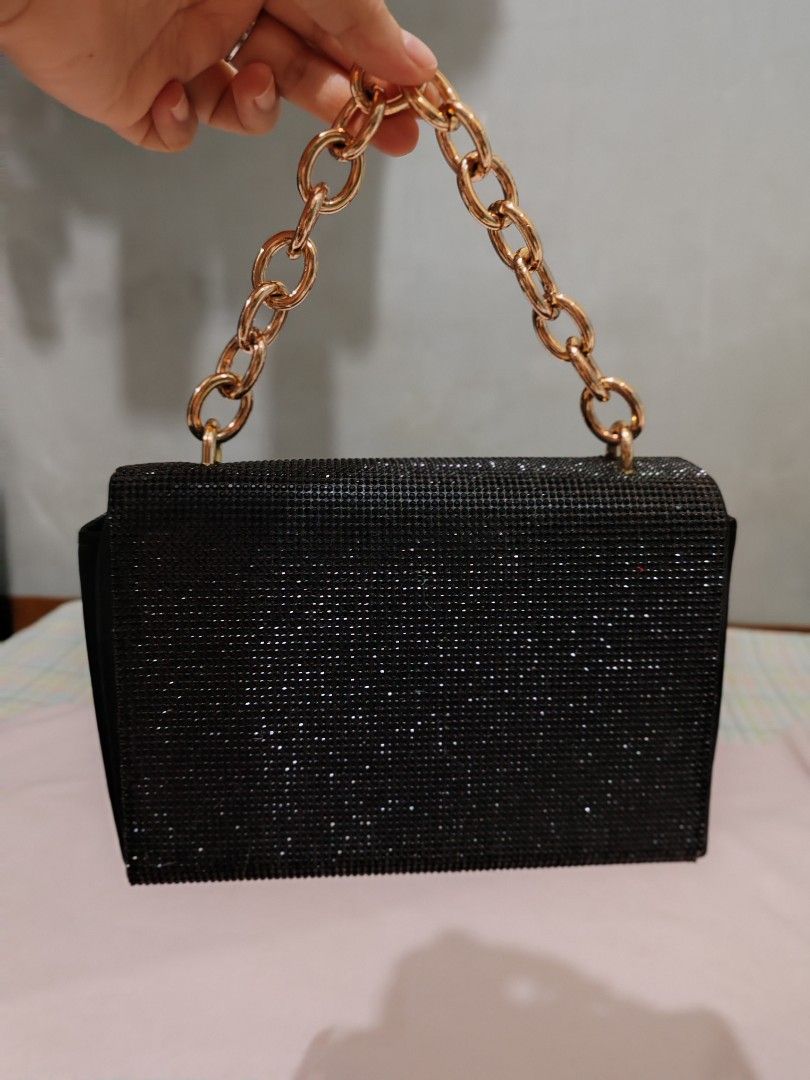 Sparkly Black Shoulder Bag with Gold Chain (Category: Shoulder Bags) located in Manila. Submitted by jazzlync (Listing ID 1440107147, Image 2). Description: - Chic black handbag - Adorned with sparkling rhinestones - Stylish gold-tone chain strap - Secure clasp closure - Ideal for evening events or as a statement piece.