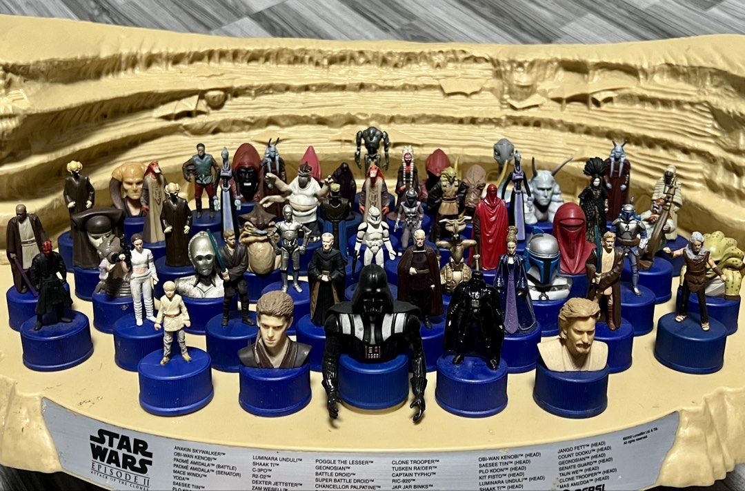 Star Wars Episode II Pepsi Bottle Cap Figures Display (Category: Vintage Collectibles) located in Manila. Submitted by thegreyhousemarket (Listing ID 1440165632, Image 3). Description: - Complete set of Star Wars Episode II Pepsi bottle cap figures. - Features characters from the movie. - Comes with a desert-themed display stand. - Includes a variety of character figures and busts. - A must-have collectible for Star Wars fans..