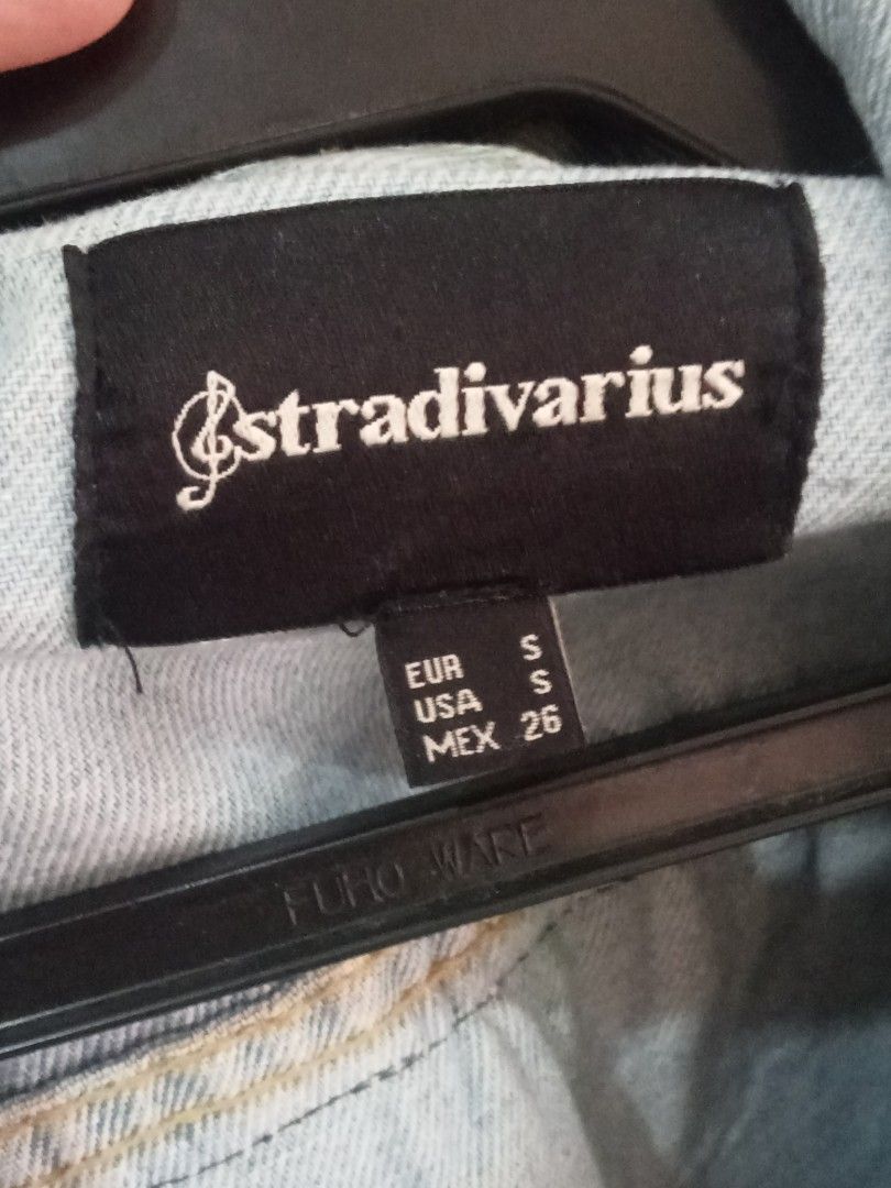 Stradivarius Denim Jacket with Embroidered Back (Category: Coats, Jackets and Outerwear) located in Paete. Submitted by glamluxxereloved (Listing ID 1440031586, Image 2). Description: S on tag but can fit Medium Pre-loved not ukay - Stradivarius light wash denim jacket - Distressed details on sleeves - Unique embroidered tribal-inspired design on back - Classic button-up front - Chest pockets - Adds a stylish edge to any outfit Vguc needs wash ka