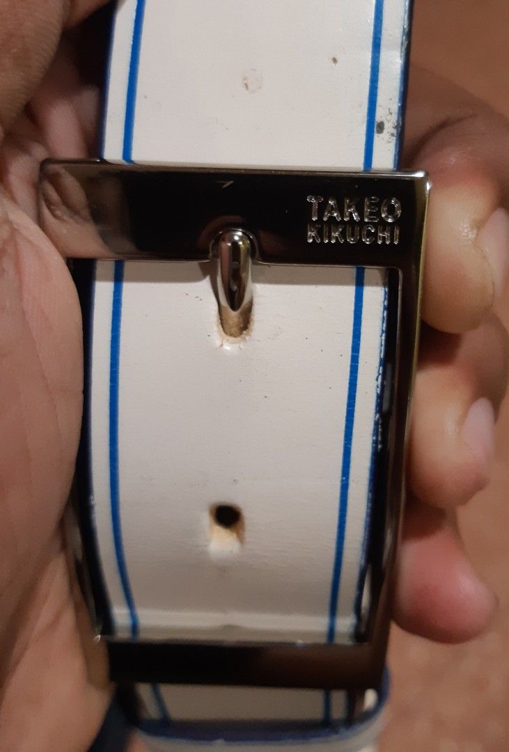 Takeo Kikuchi Belt White with Blue Stripes (Category: Belts) located in Malaybalay. Submitted by rielstuff (Listing ID 1440130072, Image 1). Description: - Brand: Takeo Kikuchi - Color: White with blue stripes - Buckle: Polished silver-tone with embossed brand name - Style: Versatile, suitable for casual and formal wear - Condition: Excellent accessory to elevate any outfit.