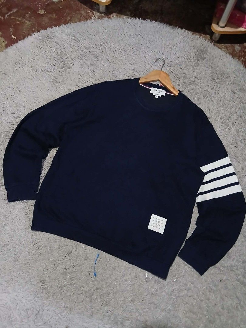 Thom Browne Navy Sweatshirt with White Stripes (Category: Luxury Apparel) located in Davao. Submitted by noelamihan05424 (Listing ID 1440085470, Image 2). Description: - Classic navy sweatshirt from Thom Browne - Features signature white stripes on the sleeve - Small woven label detail - Made in Italy - Perfect for a stylish casual look - Size 4 Large to XL fit - Dimes 22x27 - Color rate 9.5/10 - No issue .