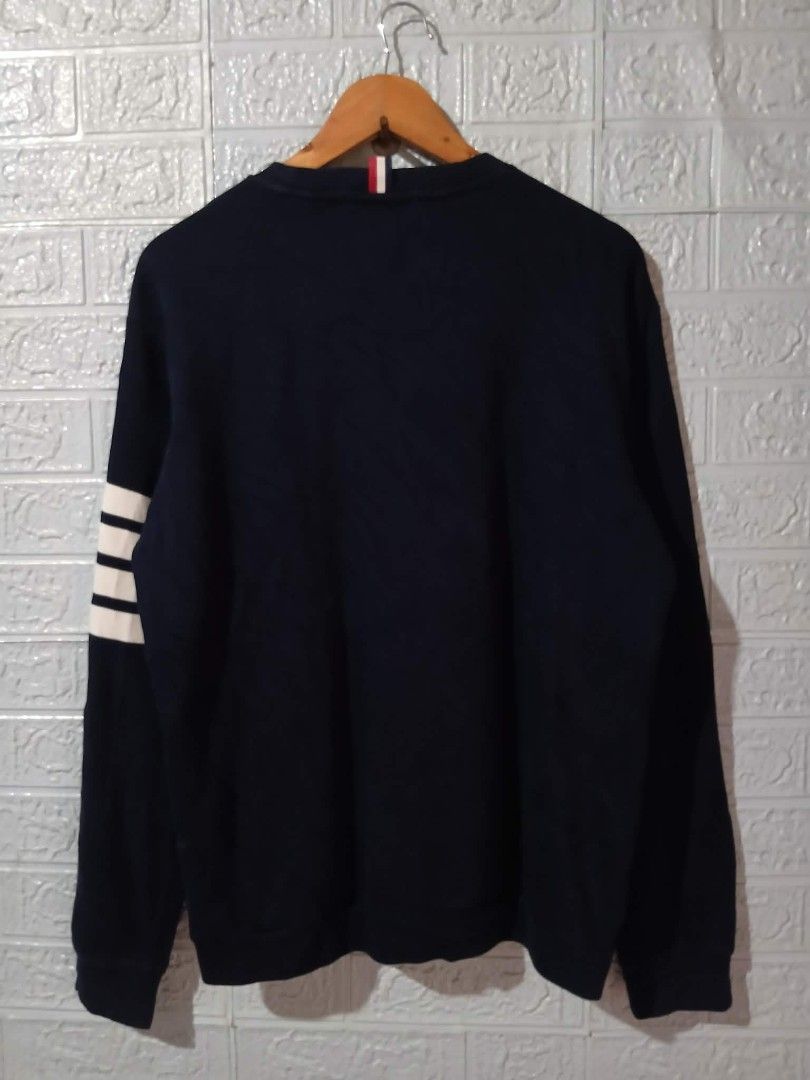 Thom Browne Navy Sweatshirt with White Stripes (Category: Luxury Apparel) located in Davao. Submitted by noelamihan05424 (Listing ID 1440085470, Image 3). Description: - Classic navy sweatshirt from Thom Browne - Features signature white stripes on the sleeve - Small woven label detail - Made in Italy - Perfect for a stylish casual look - Size 4 Large to XL fit - Dimes 22x27 - Color rate 9.5/10 - No issue .