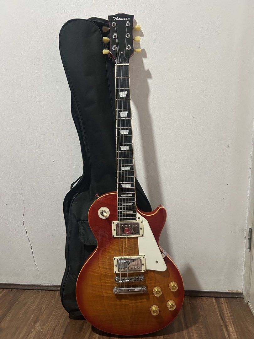 Thomson Les Paul v-series (Category: Musical Instruments) located in Quezon City. Submitted by pia_adela.secreto (Listing ID 1440188924, Image 2). Description: Thomson Les Paul V-Series cherry sunburst barely used -inclusions are bag, cable, strap, and fretwrap. -no hidden issue -stock strings issue: last pic, nagpeel yung sa may head pero ‘di naman halata - the asking price is ₱9,800 though i am open for negotiations location is ncr/quezon city 