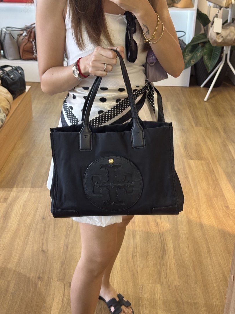 Tory Burch Black Nylon Logo Tote Bag (Category: Luxury Bags & Wallets) located in Davao. Submitted by rctongco7762375 (Listing ID 1440132581, Image 2). Description: - Authentic Tory Burch tote bag - Durable nylon with leather accents - Size medium-large -In excellent condition .