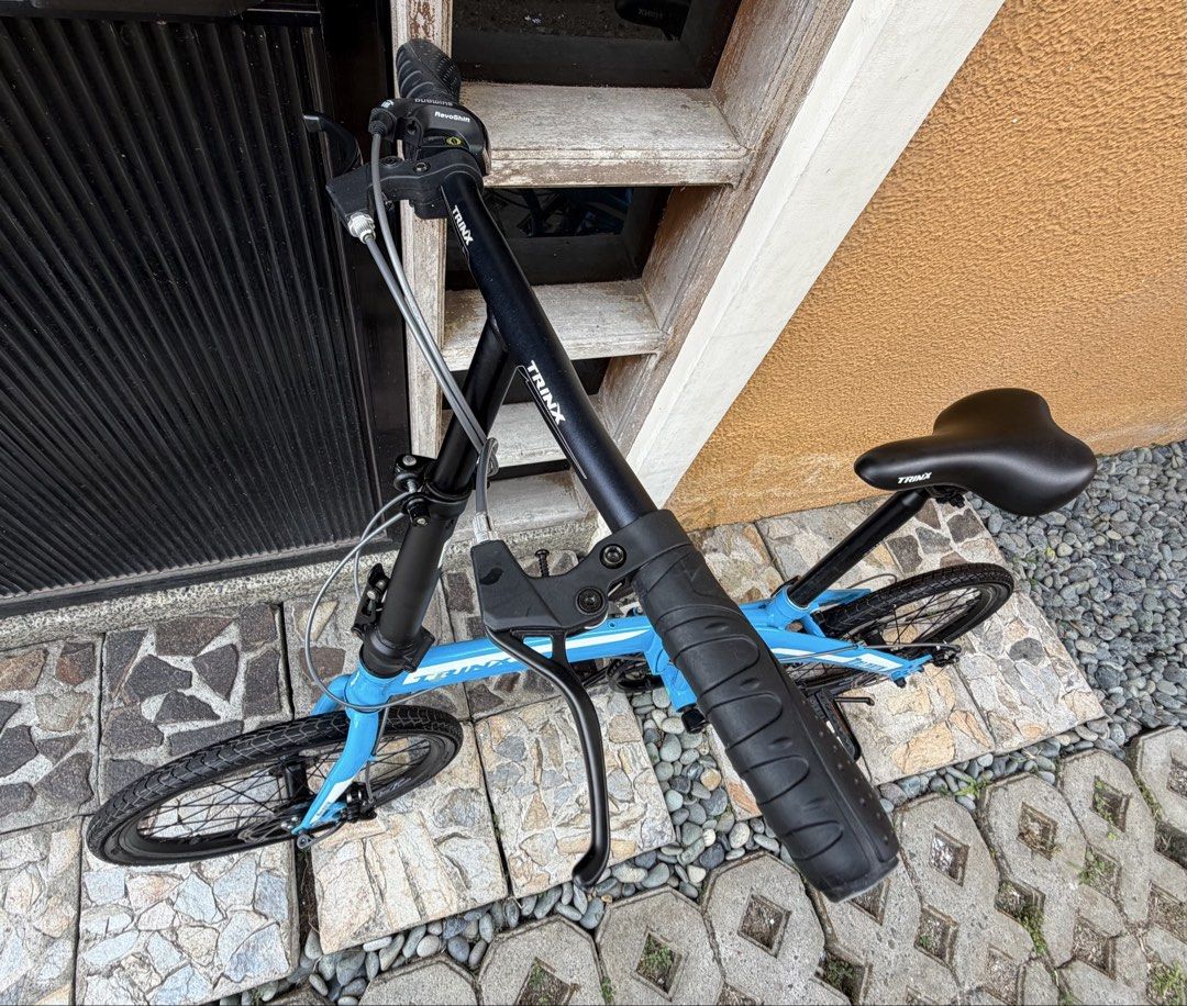 TRINX Dolphin 1.0 Folding Bike Blue (Category: Bicycles) located in Silang. Submitted by mykflor (Listing ID 1440028815, Image 3). Description: * COLOR: Blue/White * FRAME: TRINX Hi-Ten Steel 20”×290MM Folding * FORK: 20”Hi-Ten Steel * SHIFTER: SHIMANO SL-RS35-7R * RD: SHIMANO RD-TY21-B * CASSETTE: 7S 14-28T * CHAIN: M30 7S * BRAKE: TRINX Alloy Mechanical Disc * RIM: TRINX Alloy Double Wall * TYRE: P1145 , 20*1.75 * CHAINWHEEL: PROWHEEL Alloy 52T