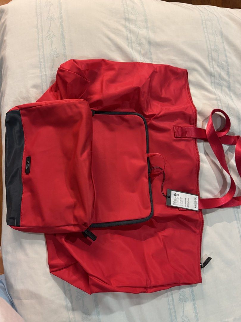TUMI Packable tote bag- Nylon Red (Category: Luxury Bags & Wallets) located in San Juan City. Submitted by kacyyuson (Listing ID 1407582676, Image 2). Description: Brand new Tumi Tote Bag - Packable Nylon Red - Eye-catching red exterior with a black top section. - Convenient top handle for easy carrying. - Secure zipper closure. - Features the iconic Tumi logo. - Designated as a Service Packable Tote..