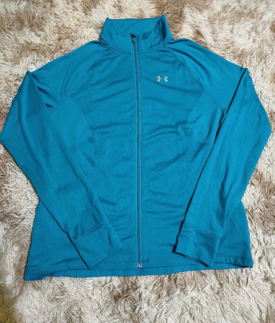 Under Armour Teal Zip-Up Jacket with Thumbholes (Category: Coats, Jackets and Outerwear) located in La Paz. Submitted by carou89146 (Listing ID 1440072498, Image 1). Description: - Under Armour teal zip-up jacket - Features convenient thumbholes - Lightweight fabric - Ideal for workouts or casual wear - Versatile addition to your active wardrobe pit to pit 22 inches length 27 inches spandex needs washing excellent condition .