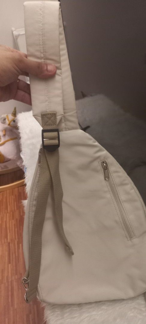 Unisex Beige Sling Bag with Adjustable Strap (Category: Cross-body Bags) located in Manila. Submitted by trychuckie (Listing ID 1440096760, Image 3). Description: - Versatile beige sling bag for everyday wear. - Main zippered compartment for secure storage. - Additional front zippered pocket for quick access. - Adjustable strap for a comfortable, customized fit. - Neutral color complements any outfit..
