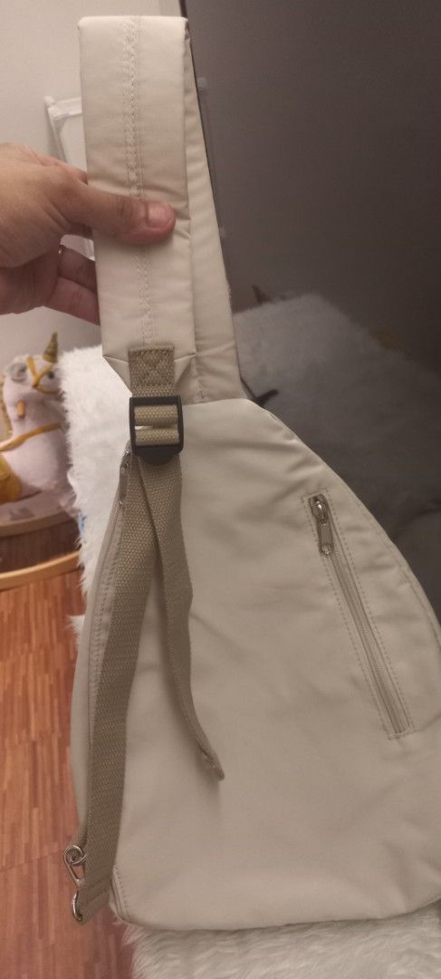 Unisex Beige Sling Bag with Adjustable Strap (Category: Cross-body Bags) located in Manila. Submitted by trychuckie (Listing ID 1440096760, Image 2). Description: - Versatile beige sling bag for everyday wear. - Main zippered compartment for secure storage. - Additional front zippered pocket for quick access. - Adjustable strap for a comfortable, customized fit. - Neutral color complements any outfit..