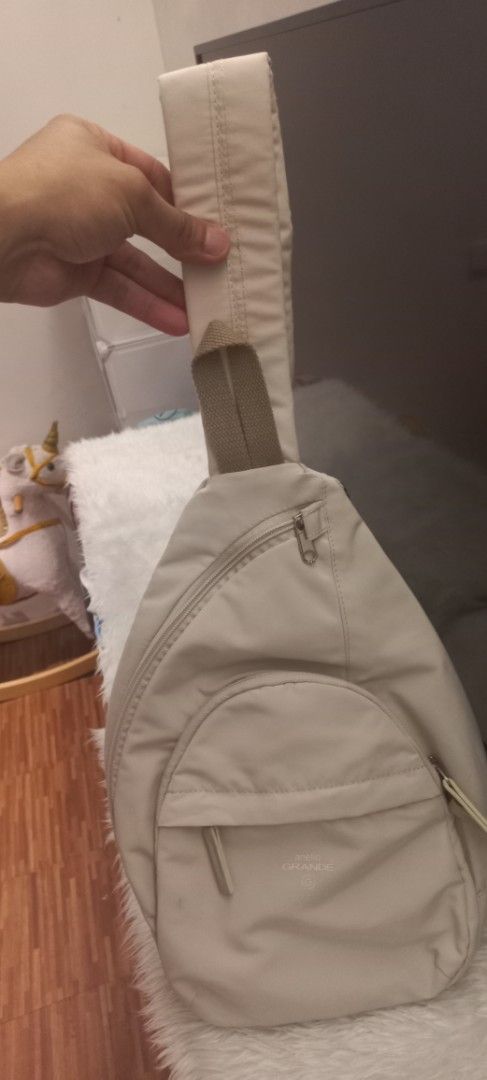 Unisex Beige Sling Bag with Adjustable Strap (Category: Cross-body Bags) located in Manila. Submitted by trychuckie (Listing ID 1440096760, Image 1). Description: - Versatile beige sling bag for everyday wear. - Main zippered compartment for secure storage. - Additional front zippered pocket for quick access. - Adjustable strap for a comfortable, customized fit. - Neutral color complements any outfit..