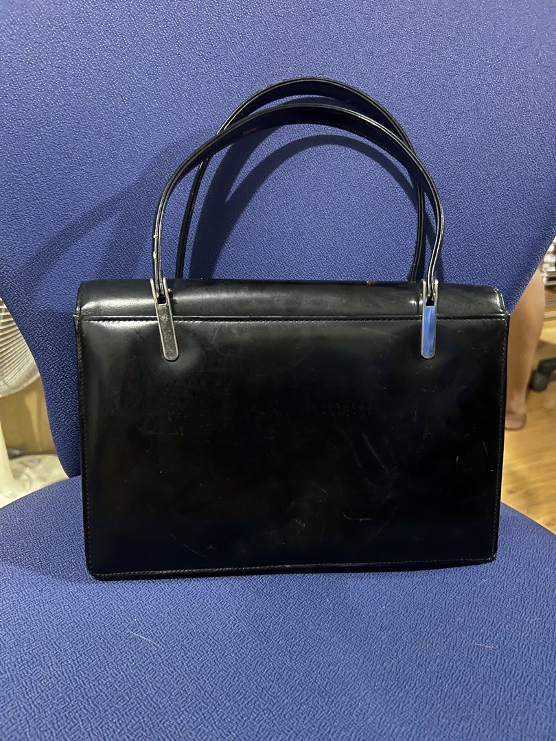 Vintage Embossed Red and Black Handbag (Category: Clutches) located in Manila. Submitted by kim.caren (Listing ID 1440079024, Image 2). Description: - Elegant vintage black handbag - Intricate embossed detailing on the front - Classic black top handle - Spacious interior with zippered pocket and slip pocket - Perfect for a touch of retro charm.
