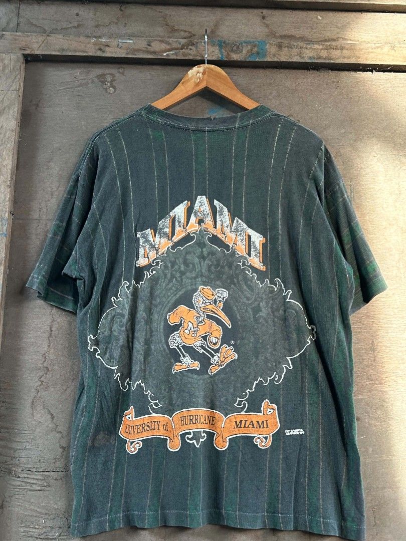 Vintage University of Miami Hurricanes Graphic T-Shirt (Category: Tshirts & Polo Shirts ) located in Polomolok. Submitted by joshualusa62716 (Listing ID 1440093426, Image 2). Description: 1993 Miami All over print 23/29 Large Vintage condition! Issue: check photos Location Polomolok South Cotabato ✈️ Ship Nation wide 📦✈️.