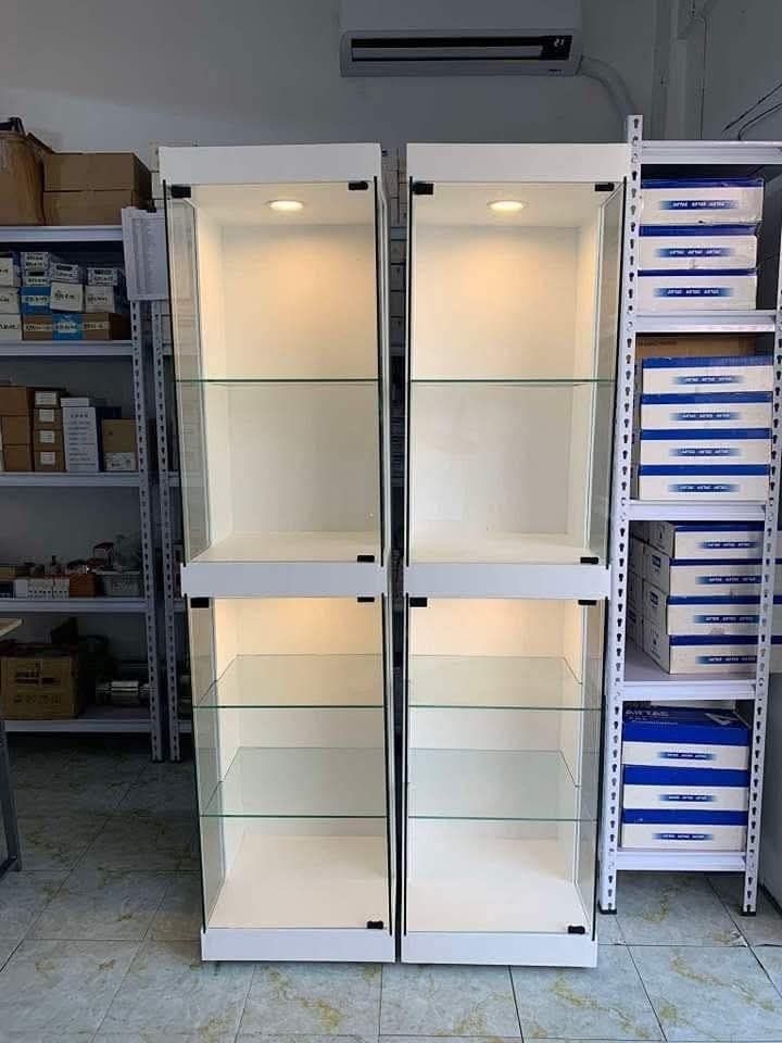 White Glass Display Cabinet with LED Lighting (Category: Shelves, Cabinets & Racks) located in Mabalacat. Submitted by joemamangun01 (Listing ID 1440001177, Image 3). Description: Showcase your collectibles with this elegant white display cabinet. Features multiple glass shelves and built-in LED lighting to highlight your items. The modern design complements any room, perfect for displaying figurines, helmets, or other prized possessions. Offers 