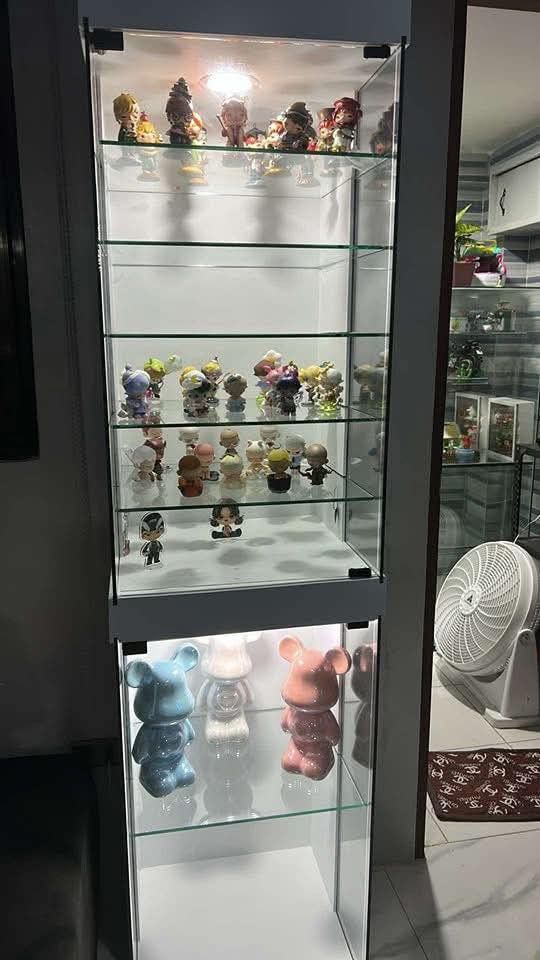 White Glass Display Cabinet with LED Lighting (Category: Shelves, Cabinets & Racks) located in Mabalacat. Submitted by joemamangun01 (Listing ID 1440001177, Image 2). Description: Showcase your collectibles with this elegant white display cabinet. Features multiple glass shelves and built-in LED lighting to highlight your items. The modern design complements any room, perfect for displaying figurines, helmets, or other prized possessions. Offers 