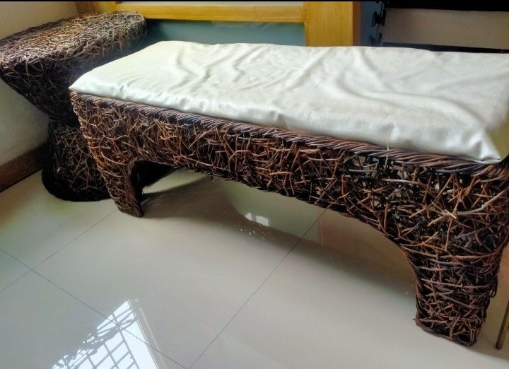 Woven Rattan Bench with White Cushion (Category: Office Furniture & Fixtures) located in Manila. Submitted by rackmnl (Listing ID 1440033870, Image 1). Description: - Stylish woven rattan bench - Comfortable white cushion included - Adds natural elegance to living room, entryway, or bedroom - Unique twig-like weaving for distinctive texture - Offers both seating and decorative appeal.
