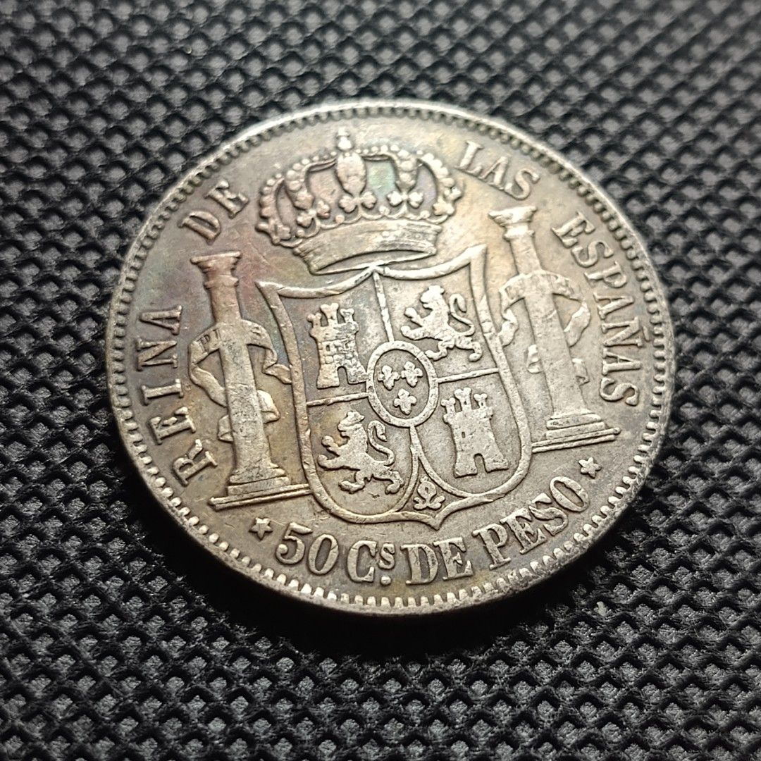 1868 Spain 50 Centimos Silver Coin Isabel II (Category: Currency) located in Quezon City. Submitted by Coiners (Listing ID 1440384538, Image 2). Description: - Vintage 1868 Spanish 50 centimos coin - Features Queen Isabel II on one side - Spanish coat of arms on the other side - Made of silver - Ideal for coin collectors.