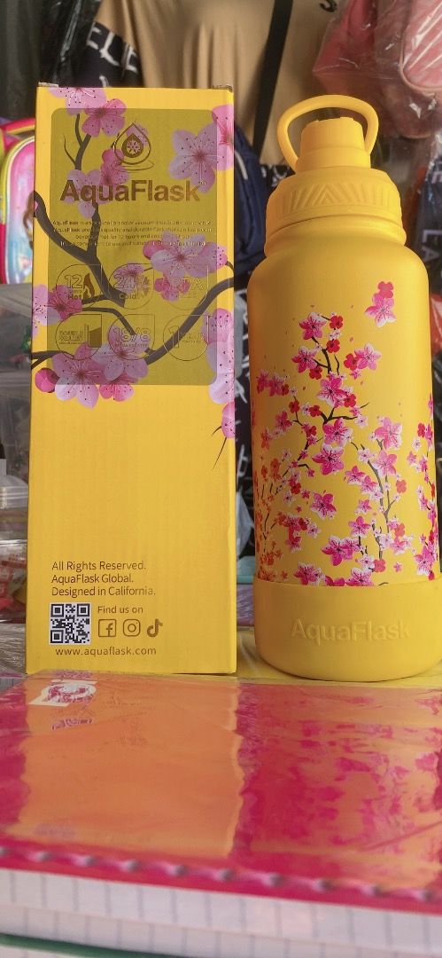 AquaFlask Sakura Yellow Water Bottle with Box (Category: Water Bottles & Tumblers) located in Bulacan. Submitted by noblestorm.b17b1b (Listing ID 1440265366, Image 2). Description: - Yellow AquaFlask water bottle - Features a cute Sakura cherry blossom design - Comes with its original yellow packaging - Excellent for keeping beverages hot or cold - Ideal for everyday hydration or as a collectible item.