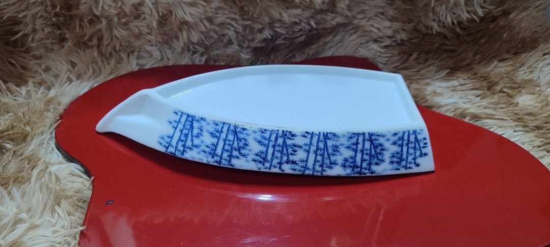 Arita White Ceramic Serving Platter with Blue Bamboo Design (Category: Dinnerware & Cutlery) located in Makati City. Submitted by sassymaja (Listing ID 1440236580, Image 2). Description: - Elegant white ceramic serving platter - Features a delicate blue bamboo pattern along the edge - Unique shape, ideal for appetizers, sushi, or desserts - Adds a touch of sophistication to any table setting -Perfect for sushi or siomai serving platter.