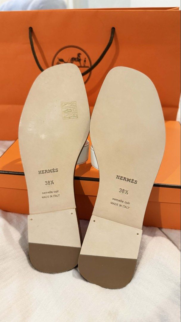 Authentic Hermes Oran Sandals in White size 38.5 (Category: Flats & Sandals) located in Paranaque City. Submitted by coffeebeanss (Listing ID 1440274649, Image 3). Description: authentic Hermes Oran Sandals in White 🤍 - size 38.5 - purchased in Osaka last year, never worn - selling these much lower than SRP - rfs: impulse purchase, already have this style in other colors - comes with individual shoe bags, box, paper bag.
