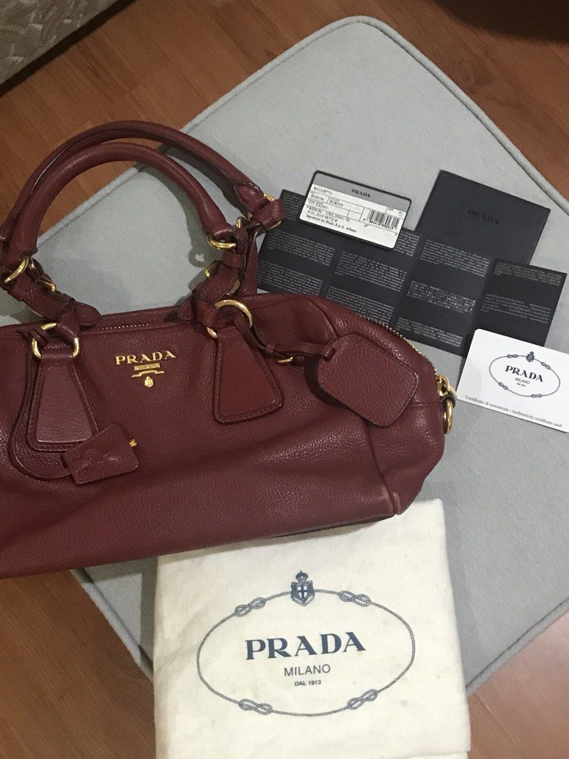 Authentic Prada Red Leather Bag bought from Prada (Category: Luxury Bags & Wallets) located in Quezon City. Submitted by katie8michelle (Listing ID 1440331970, Image 1). Description: Great condition, bought in a Prada store in New York. Rarely used because i prefer small sling bags. Actual bag is in great condition, but dust bag has loose thread. Negotiable. .