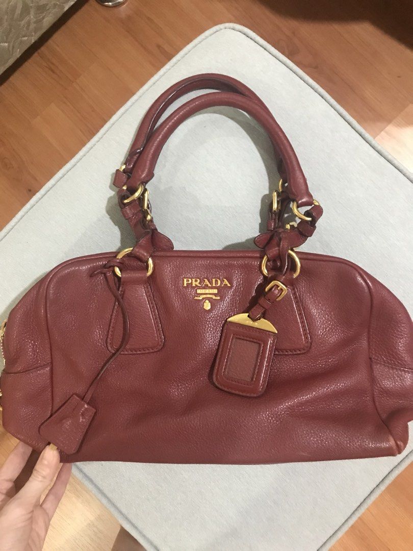 Authentic Prada Red Leather Bag bought from Prada (Category: Luxury Bags & Wallets) located in Quezon City. Submitted by katie8michelle (Listing ID 1440331970, Image 2). Description: Great condition, bought in a Prada store in New York. Rarely used because i prefer small sling bags. Actual bag is in great condition, but dust bag has loose thread. Negotiable. .