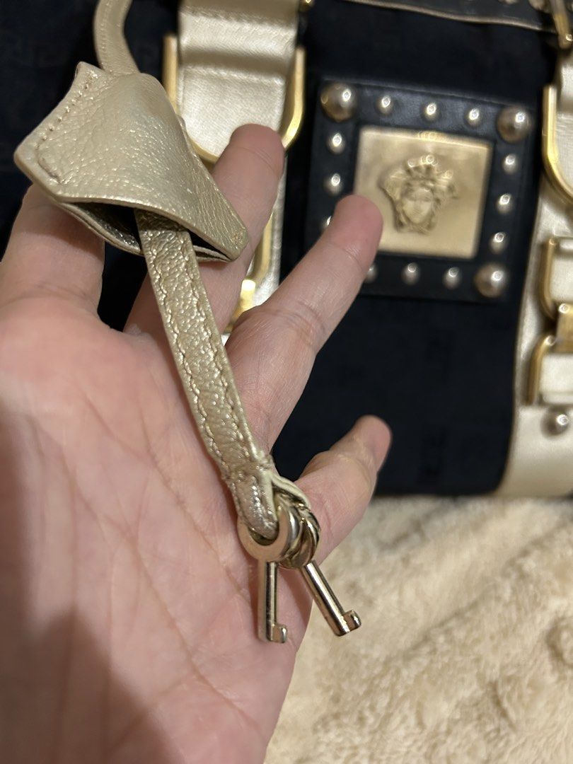 Authentic Vintage Versace Medusa bowler bag (Category: Luxury Bags & Wallets) located in Cebu City. Submitted by vedazzle (Listing ID 1440208064, Image 3). Description: 📍Clean interior and exterior and very spacious. Medyo may kabigatan. 📍Studded trim 📍Braided metallic handles 📍Bauletto/bowler silhouette 📍Dual-tone leather straps 📍Side lock detail with keys.