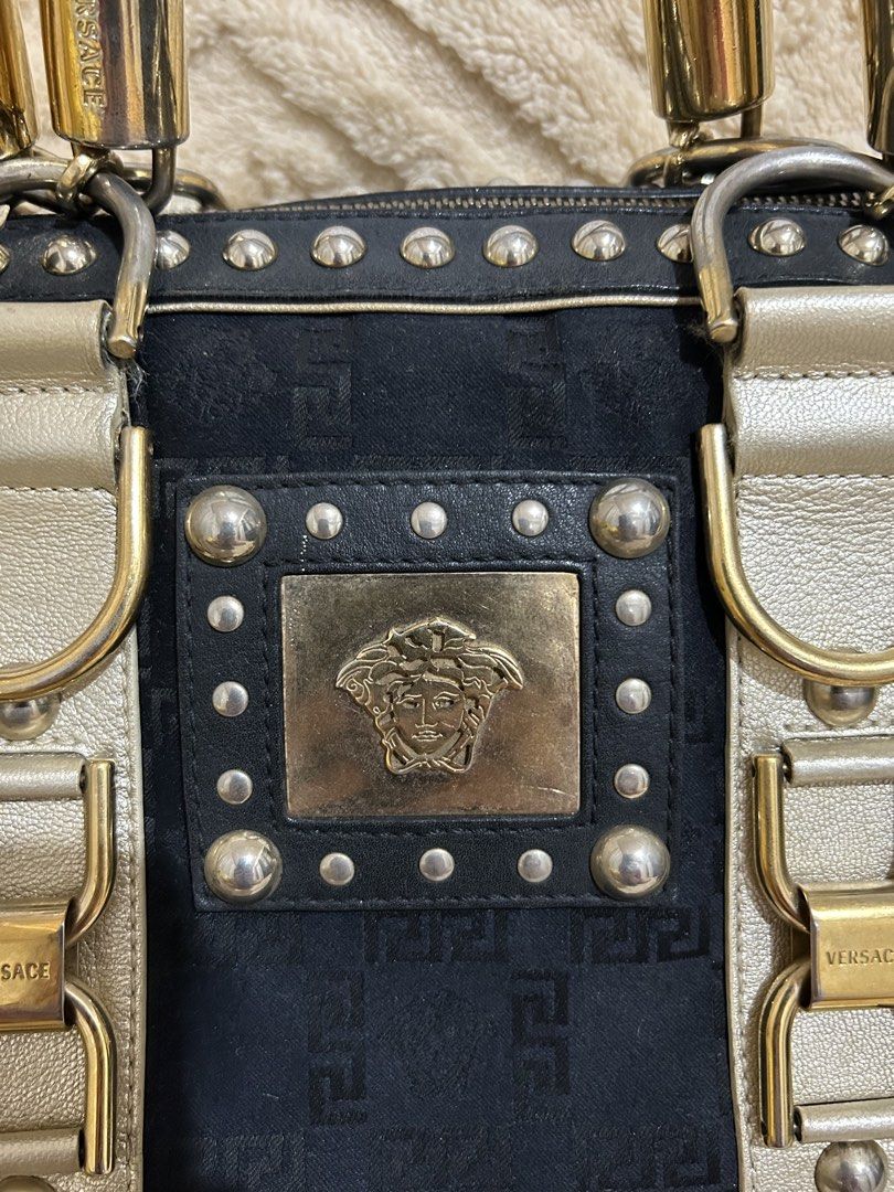 Authentic Vintage Versace Medusa bowler bag (Category: Luxury Bags & Wallets) located in Cebu City. Submitted by vedazzle (Listing ID 1440208064, Image 2). Description: 📍Clean interior and exterior and very spacious. Medyo may kabigatan. 📍Studded trim 📍Braided metallic handles 📍Bauletto/bowler silhouette 📍Dual-tone leather straps 📍Side lock detail with keys.