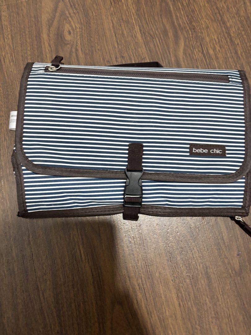 Bebe Chic Striped Changing Pad Clutch (Category: Changing Mats & Accessories) located in Pasig City. Submitted by 7preloved (Listing ID 1440298276, Image 1). Description: - Bebe Chic changing pad clutch - Stylish navy and white stripes - Compact and folds neatly - Interior pockets for diapers and wipes - Ideal for convenient on-the-go diaper changes.