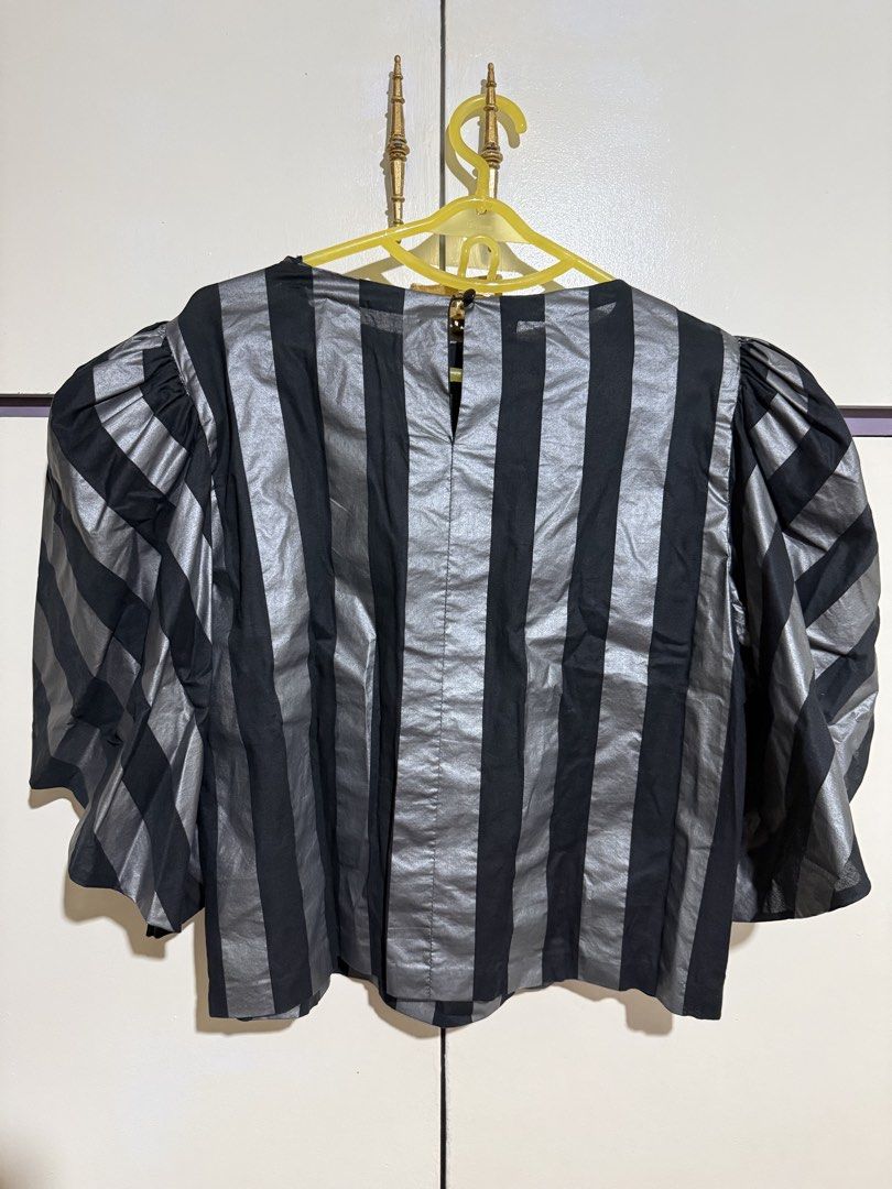 Black and Silver Striped Puff Sleeve Top (Category: Blouses) located in Marikina City. Submitted by stuffs23 (Listing ID 1440304716, Image 2). Description: - Cool black and silver striped cropped top - Features dramatic puff sleeves - Fabric has a slight sheen for a touch of elegance - Ideal for a night out or as a statement piece - Convenient back zipper closure.