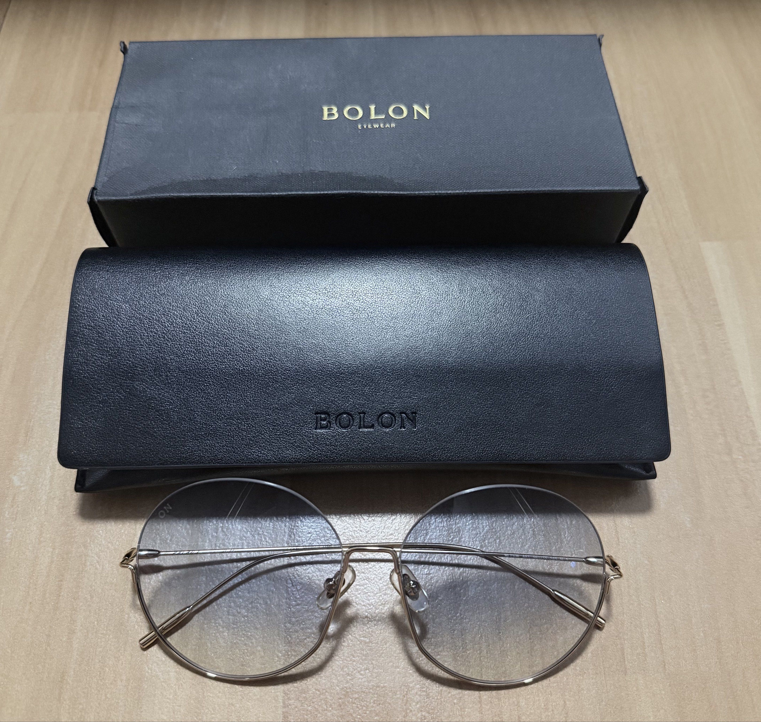 BOLON Round Rimless Sunglasses (Category: Sunglasses & Eyewear) located in Manila. Submitted by heypreloved2016 (Listing ID 1440341904, Image 1). Description: - Brand: BOLON - Style: Round Sunglasses - Frame: Thin gold-tone metal - Lenses: Clear with a slight gradient - Condition: Excellent (includes original black leather case and box) - Perfect for: Everyday wear, adding a stylish touch to any outfit.