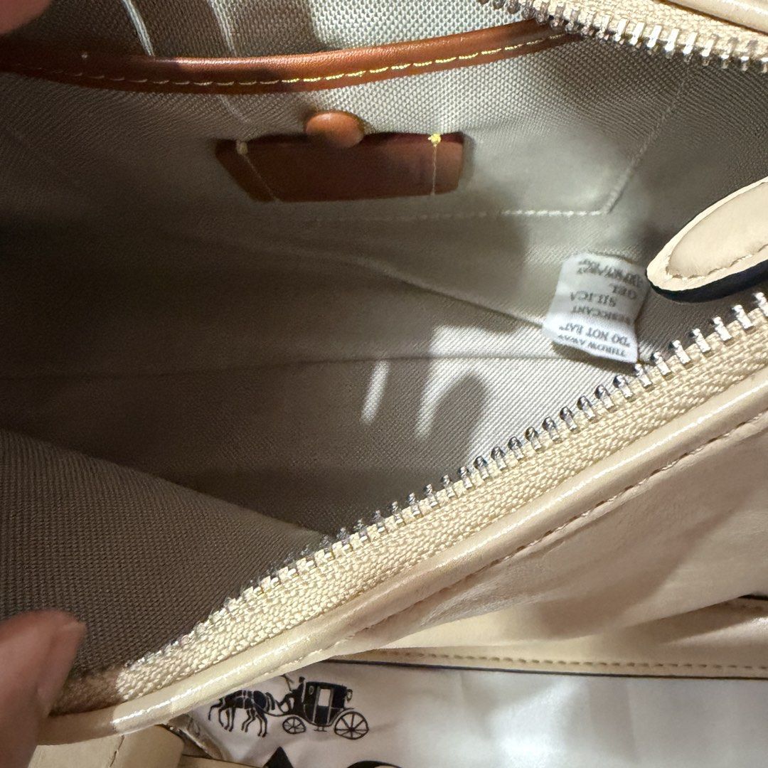Coach Juliet Medium Size Ivory Shoulder / Crossbody bag (Category: Shoulder Bags) located in Quezon City. Submitted by active_assets (Listing ID 1439604549, Image 2). Description: - Beige Coach shoulder bag - convertible to crossbody - Zip closure - Detachable shoulder strap - Silver-tone chain strap - Interior pocket - Leather tag - Coach logo on front.