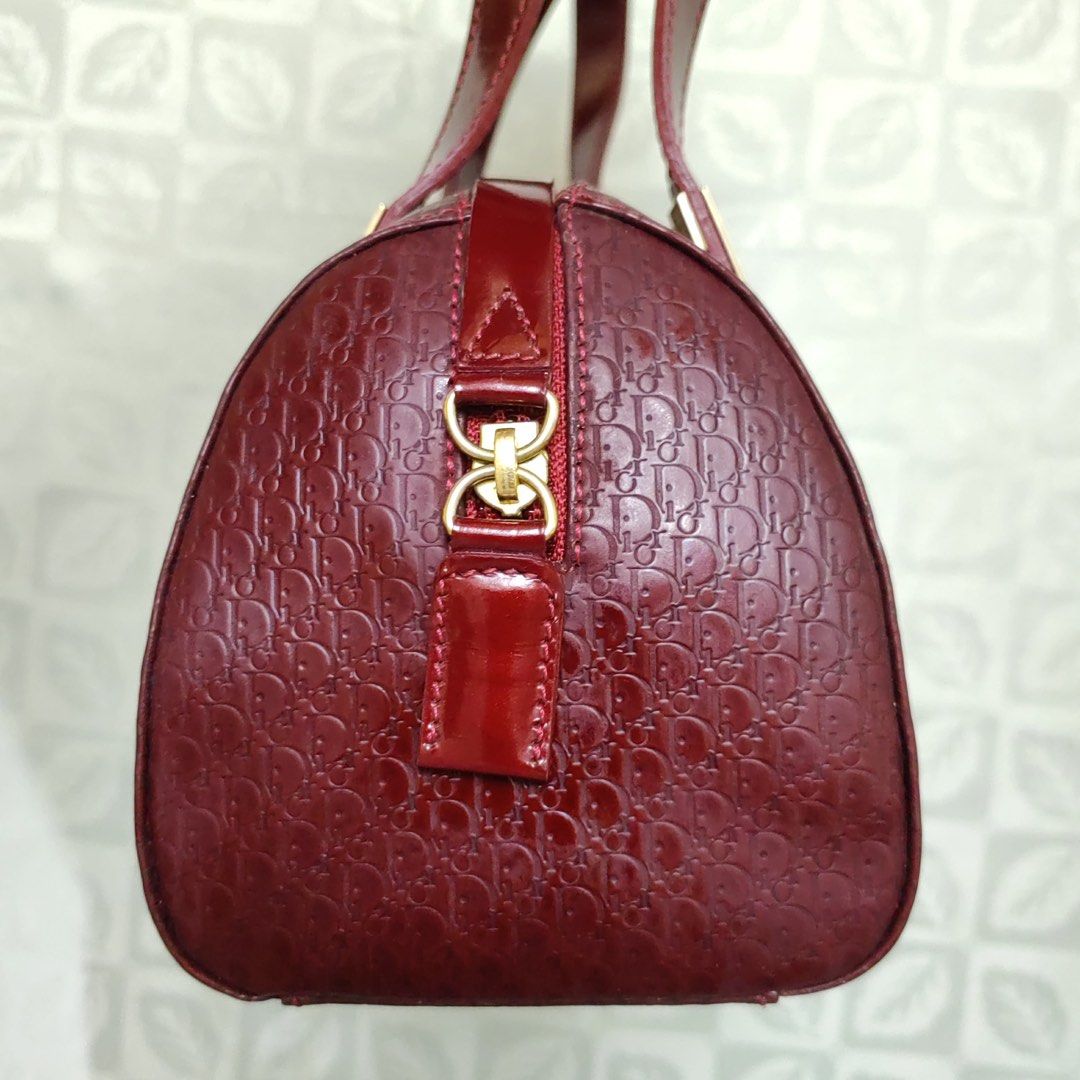 Christian Dior Monogram Patent Leather Handbag (Category: Luxury Bags & Wallets) located in Quezon City. Submitted by blessed.gem (Listing ID 1440321984, Image 2). Description: - Vintage Authentic Christian Dior handbag Design: It features the iconic Dior Oblique monogram pattern in a deep red (burgundy) color with a glossy, patent-like finish. Hardware: The bag has gold-tone hardware, specifically distinctive rectangular metal tabs at the base o