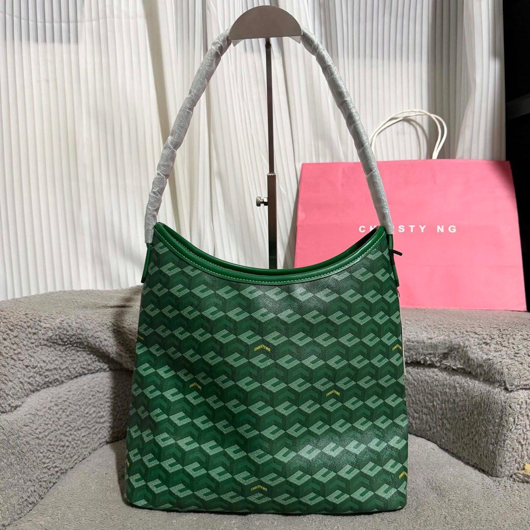 Christy Ng Alesso Large (Category: Luxury Bags & Wallets) located in Guimba. Submitted by brazaschri03660 (Listing ID 1440363698, Image 2). Description: - Stylish green shoulder bag with a repeating monogram pattern. - Strap still has protective plastic on it. - Includes a complimentary pink shopping bag. - Ideal for everyday wear and errands..