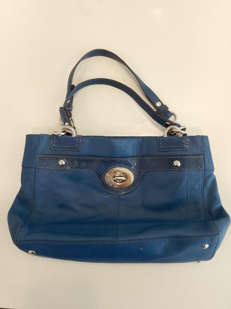 Coach Blue Leather Shoulder Bag with Turnlock Closure (Category: Luxury Bags & Wallets) located in Iloilo. Submitted by janillthrifted (Listing ID 1440205092, Image 1). Description: - Authentic Coach shoulder bag - Vibrant blue leather - Signature turnlock closure - Textured accents on front strap - Light-colored fabric interior - Interior zippered pocket - Made in Vietnam - Stylish and practical for everyday use.