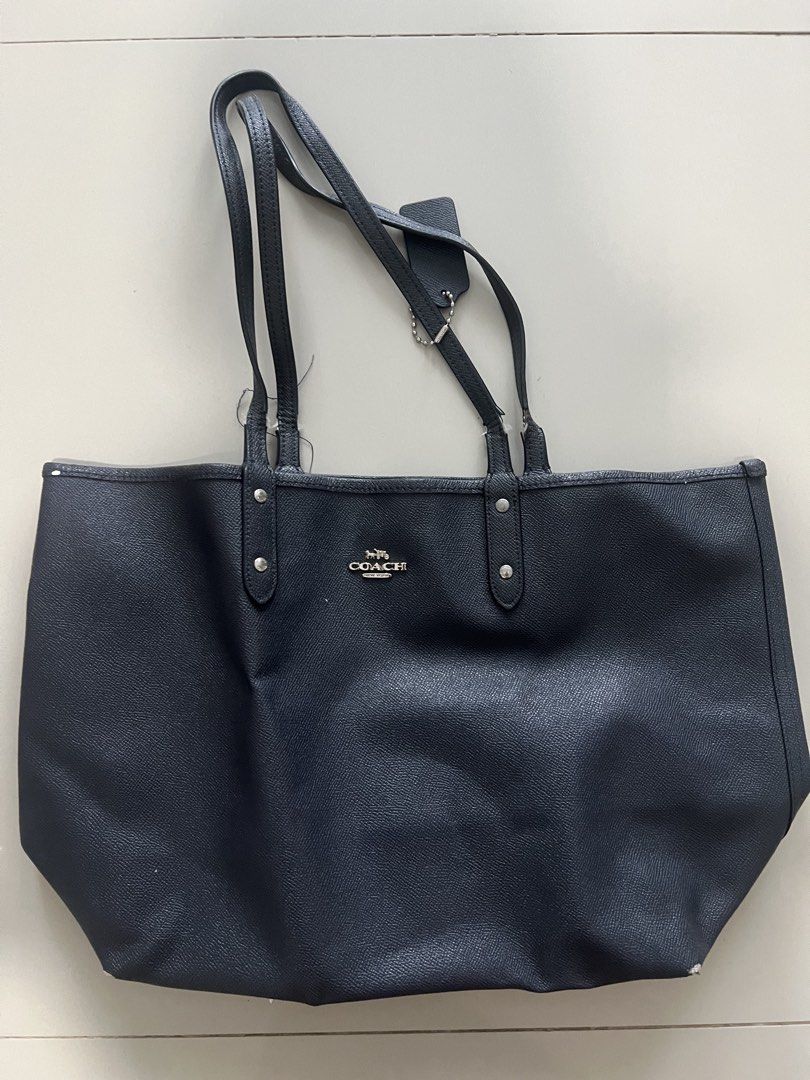 Coach Navy Pebbled Leather Tote Bag (Category: Luxury Bags & Wallets) located in Paranaque City. Submitted by sparkspark1026 (Listing ID 1440222958, Image 1). Description: - Classic navy blue Coach tote bag - Made from durable pebbled leather - Spacious interior, ideal for everyday or travel - Comfortable double shoulder straps - Elegant silver hardware details - Includes original Coach hang tag Love this so much but i dont use it anymore.