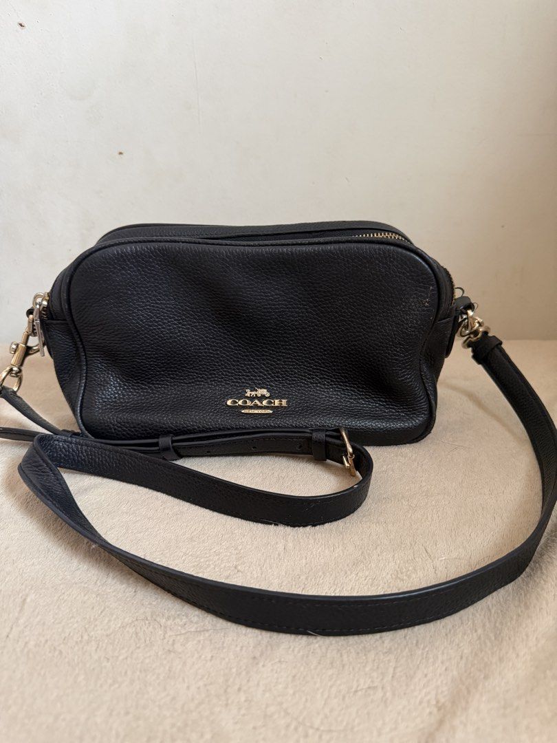 Coach Pebble Leather Crossbody Bag Black (Category: Cross-body Bags) located in Pasig City. Submitted by sellingitlow (Listing ID 1440241625, Image 1). Description: - Brand: Coach - Material: Black pebbled leather - Style: Crossbody bag - Features: Two zippered compartments, gold hardware details, adjustable shoulder strap - Model Number: M1877-F39856 - Ideal for: Everyday use -Fits long wallet and all outfits. -Classy look.