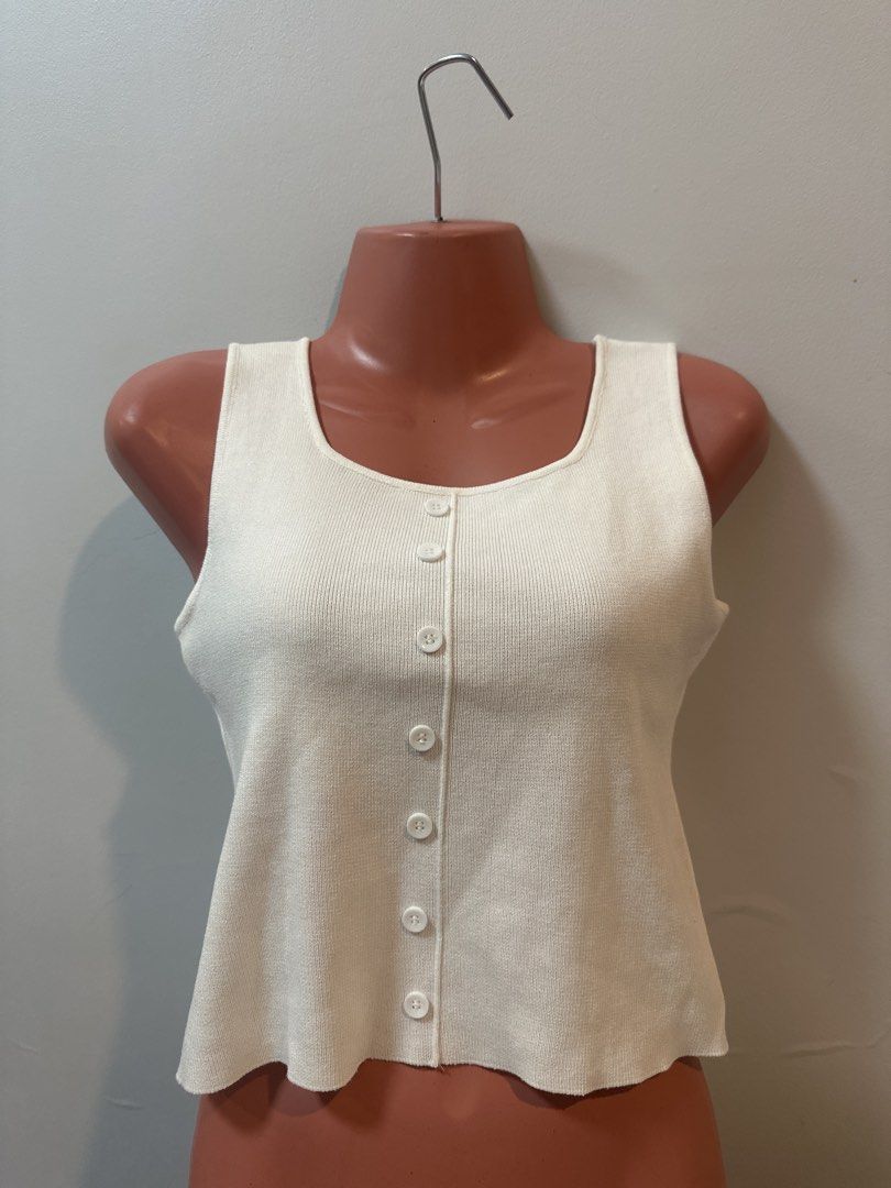 Cream Ribbed Button Front Tank Top (Category: Sleeveless) located in Las Pinas. Submitted by Mkdot (Listing ID 1440267199, Image 1). Description: - Cream ribbed tank top - Square neckline with button front detail - Sleeveless design - Soft knit material - Perfect for layering or wearing on its own - Versatile color that matches everything.
