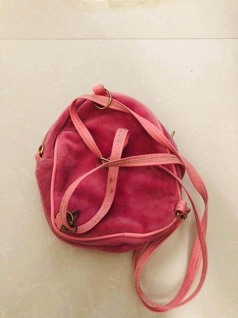 Cute pink cat mini backpack (Category: Other Babies Going Out Needs) located in Las Pinas. Submitted by bibliomomma (Listing ID 1440208245, Image 3). Description: Cute pink cat mini backpack/crossbody bag with soft velvet-like material and embroidered cat face detail. Features adjustable straps, working zippers, and multiple compartments for small essentials. Pre-loved with washable flower stains inside and light signs of use, but still cute and 