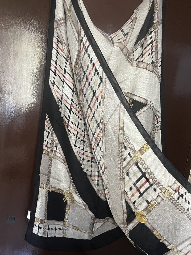 DAKS Scarf Silk Blend Tartan Chain Print (Category: Scarves) located in Cebu City. Submitted by 7paws (Listing ID 1440377420, Image 2). Description: - Classic DAKS scarf - Features tartan and chain print - Black border detail - Material feels like a silk blend - Approximate measurements: 35 x 35 inches - A versatile accessory to elevate any outfit.