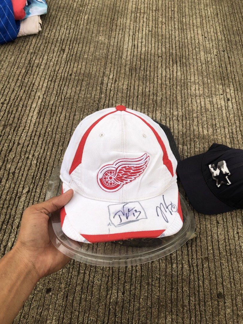Detroit Red Wings Baseball Cap with Autographs (Category: Caps & Hats) located in Manila. Submitted by leklekthrift (Listing ID 1440222162, Image 1). Description: - Show your support for the Detroit Red Wings with this baseball cap. - Features the iconic Red Wings logo embroidered on the front. - Includes two visible autographs on the brim for a unique fan collectible. - Perfect for wearing to games or as part of your everyday style..