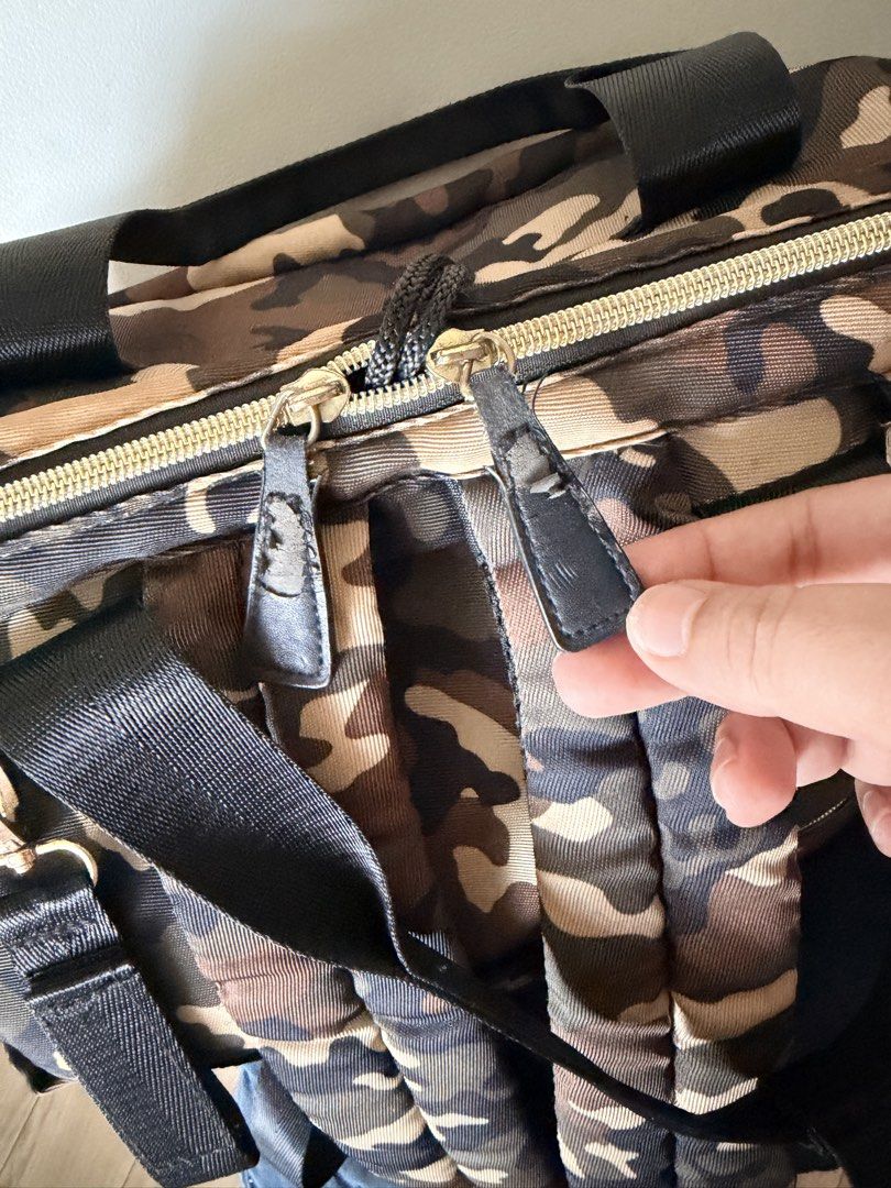 Diaper Bag Camouflage Backpack with Multiple Pockets (Category: Diaper Bags & Wetbags) located in Malolos. Submitted by findandmore (Listing ID 1440331590, Image 3). Description: - Stylish camo print backpack - Multiple pockets for excellent organization - Spacious main compartment - Convenient side pockets - Adjustable straps for a comfortable fit - Zippers have some wear, as pictured - Ideal for everyday use or travel adventures.