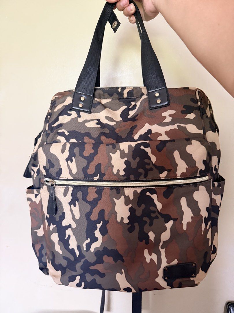 Diaper Bag Camouflage Backpack with Multiple Pockets (Category: Diaper Bags & Wetbags) located in Malolos. Submitted by findandmore (Listing ID 1440331590, Image 1). Description: - Stylish camo print backpack - Multiple pockets for excellent organization - Spacious main compartment - Convenient side pockets - Adjustable straps for a comfortable fit - Zippers have some wear, as pictured - Ideal for everyday use or travel adventures.