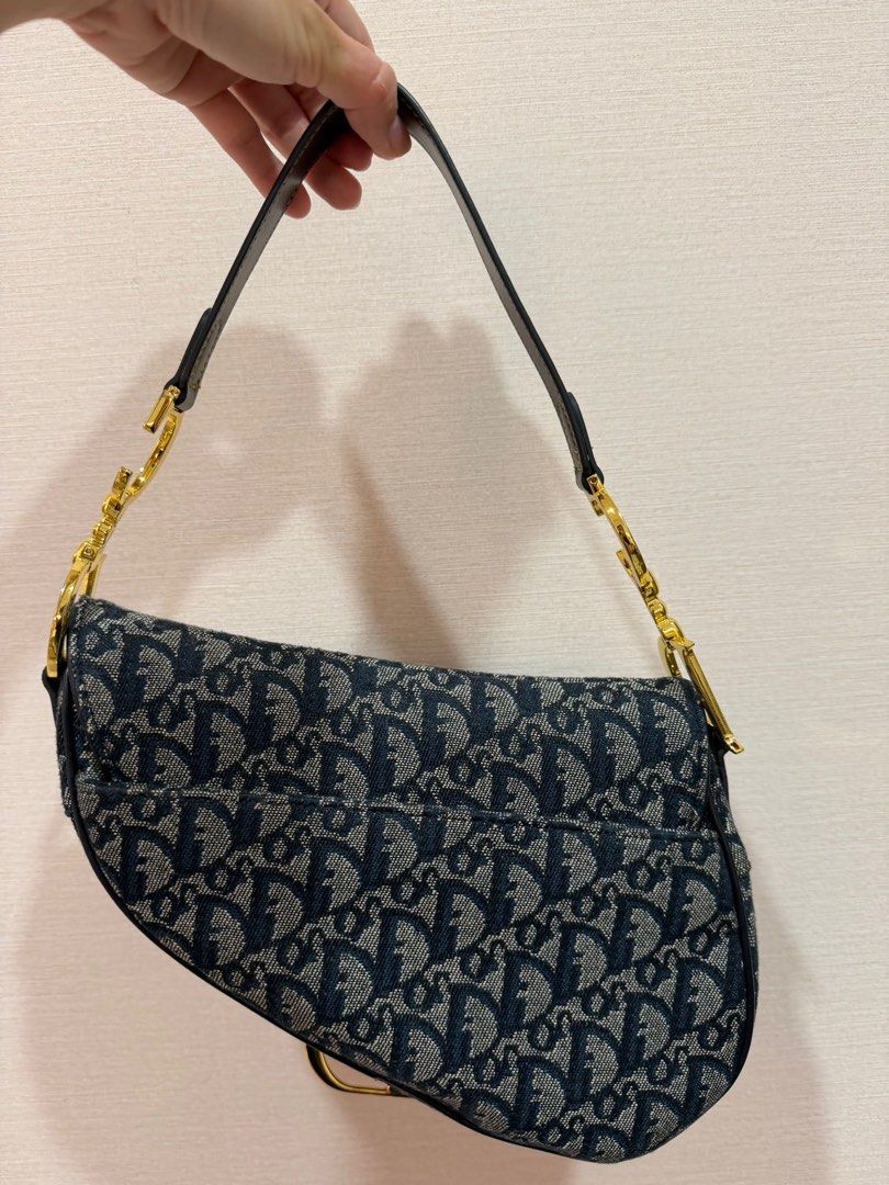 Dior saddle (vintage) (Category: Bags & Wallets) located in Singapore. Submitted by a.meliaa (Listing ID 1440274067, Image 2). Description: Vintage pre-loved, bought from japan Condition: excellent Calfskin leather & canvas Navy blue, gold hardware with velcro tab Year: 2002 (estimated) No receipt/dustbag, only purchase if you are comfortable.