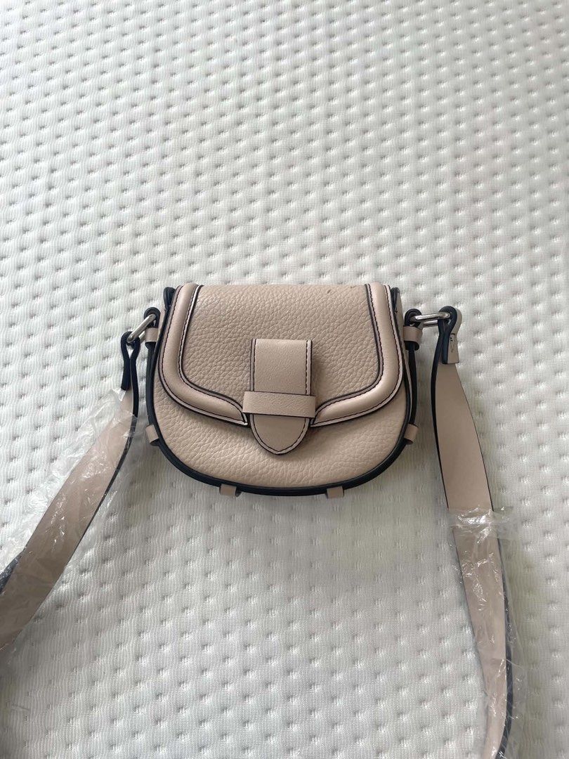 Esprit Beige Pebble Leather Saddle Bag unused (Category: Cross-body Bags) located in Caloocan City. Submitted by bountycart (Listing ID 1440244176, Image 3). Description: - Esprit saddle bag in a chic beige color. - Features a classic pebble leather texture. - Secure flap closure with an elegant buckle detail. - Adjustable strap for comfortable, customized wear. - Ideal for everyday use with its clean and simple design..