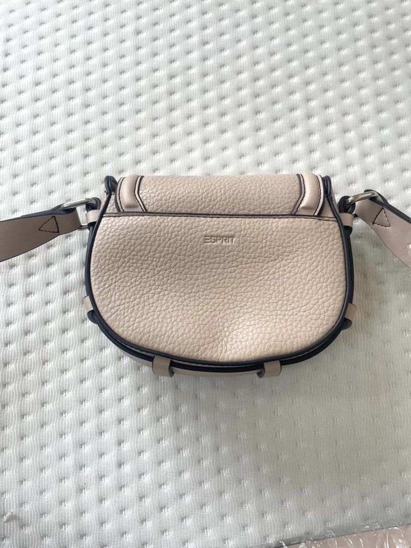 Esprit Beige Pebble Leather Saddle Bag unused (Category: Cross-body Bags) located in Caloocan City. Submitted by bountycart (Listing ID 1440244176, Image 1). Description: - Esprit saddle bag in a chic beige color. - Features a classic pebble leather texture. - Secure flap closure with an elegant buckle detail. - Adjustable strap for comfortable, customized wear. - Ideal for everyday use with its clean and simple design..