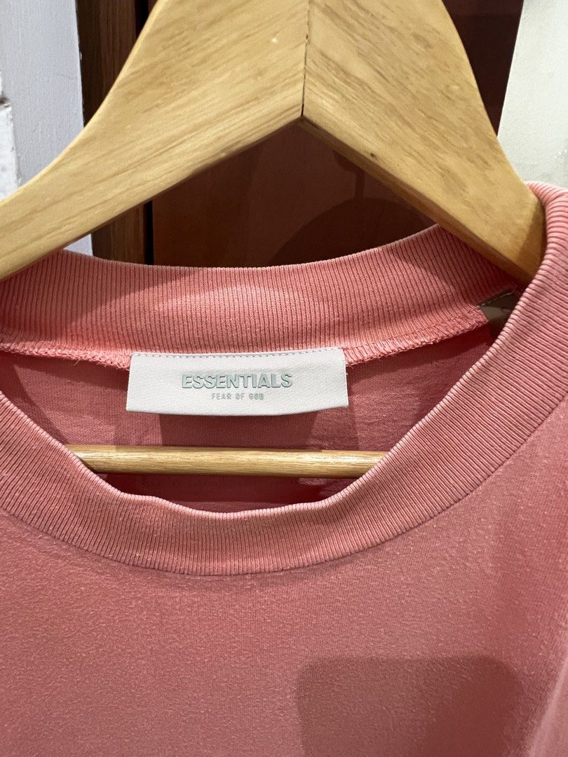 Fear of God Essentials T-Shirt Coral Pink Size S (Category: Tshirts & Polo Shirts ) located in Manila. Submitted by thejenclai01765 (Listing ID 1440360801, Image 2). Description: - Coral pink Fear of God Essentials t-shirt - Classic embossed 'Essentials' logo on the chest - Short sleeves - Comfortable fit - Size S - Ideal for casual wear.