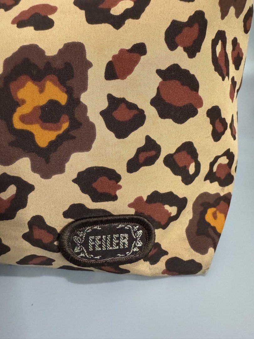 FEILER Leopard Print Tote Bag (Category: Tote Bags) located in Bacoor. Submitted by curatedbylois (Listing ID 1440266815, Image 2). Description: Pre-owned and in good condition - Brand: FEILER - Design: Leopard print - Material: Canvas with leather handles - Features: 2 interior pockets for organization Note: -with minimal crackings on the handle.